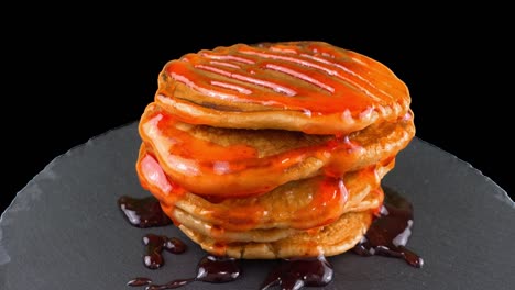 pancakes with strawberry topping. pancake lies on a black slate round stone. alpha channel included.