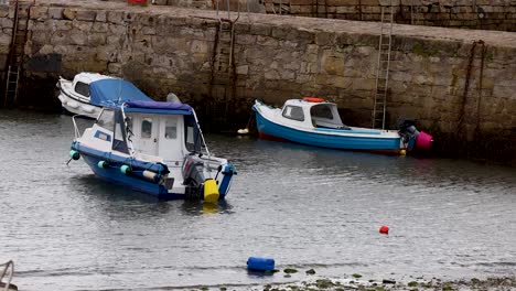 two boats docked in a scottish harbor