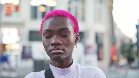 urban portrait of a young person with vibrant pink hair