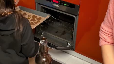 putting gingerbread cookie dough in the oven - slow motion