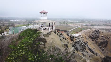 Drone-rotates-around-beautiful-lookout-sitting-atop-a-steep-cliff-side