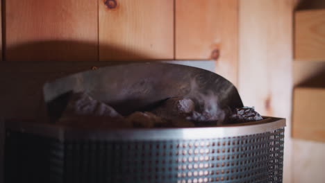 close-up of a sauna heater with hot stones