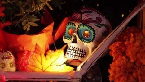 Painted-Día-de-muertos-skull-on-altar-with-other-festival-decorations