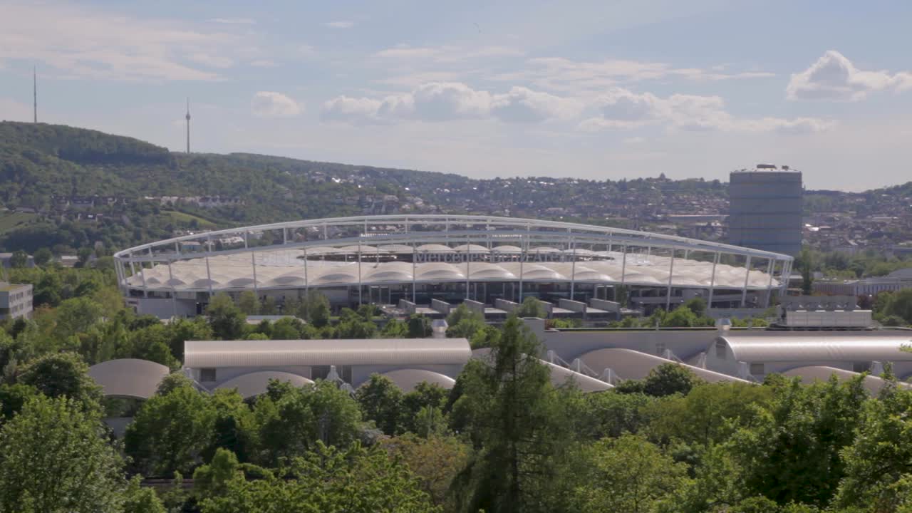 Mercedes-benz arena in stuttgart on a sunny day with greenery in the foreground, aerial view