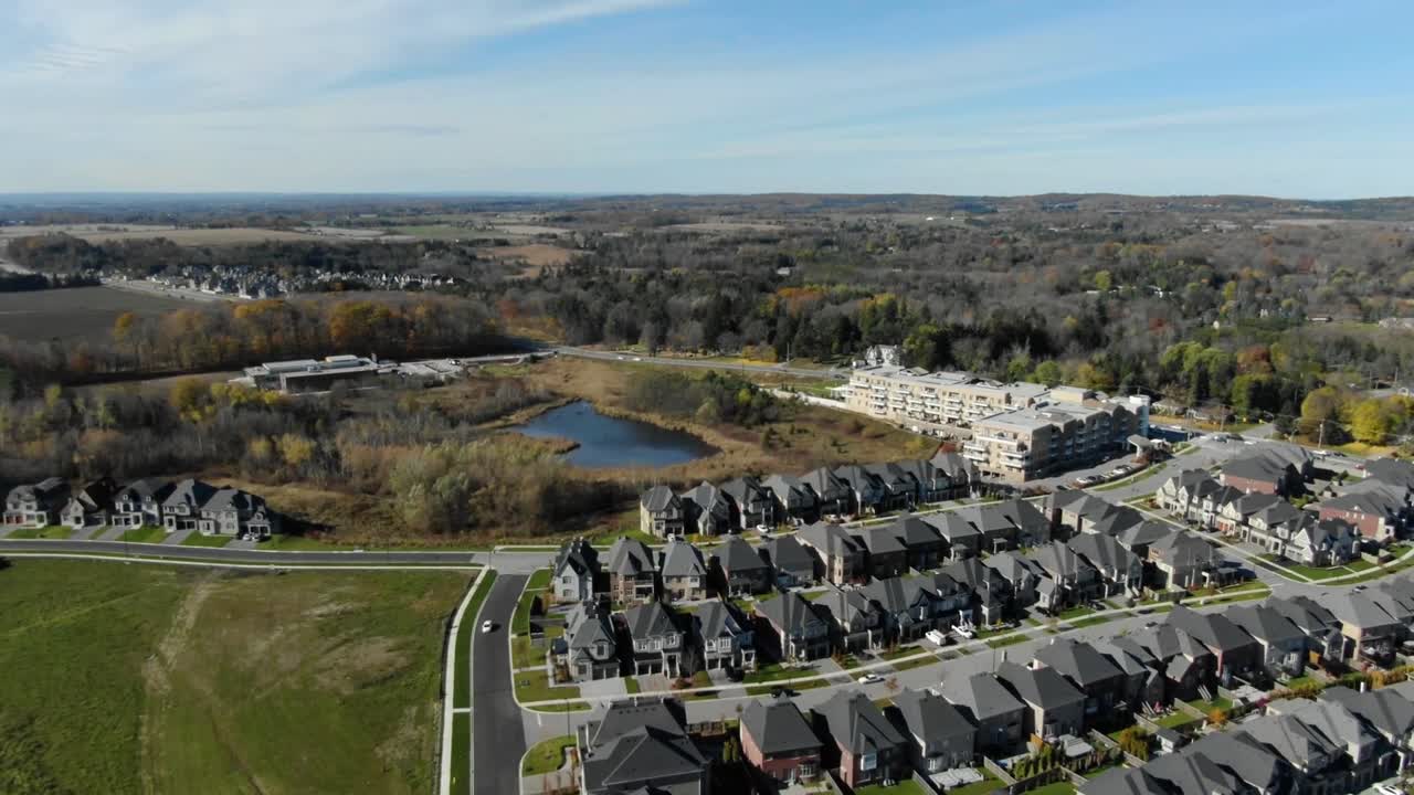 Drone flying over King City neighborhood near a pond
