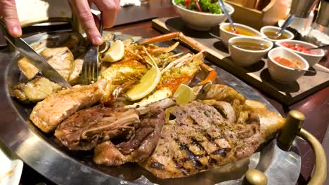 delicious grilled seafood and meat with sauces