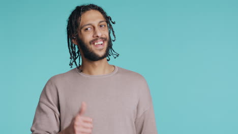 man doing thumbs up hand gesturing, showing approval, having positive mood