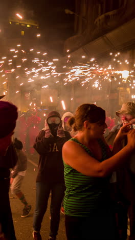 barcelona, spain - 22 september 2023 : crowds in the street for the fire run or correfoc, during la merce festival, barcelona spain in vertical