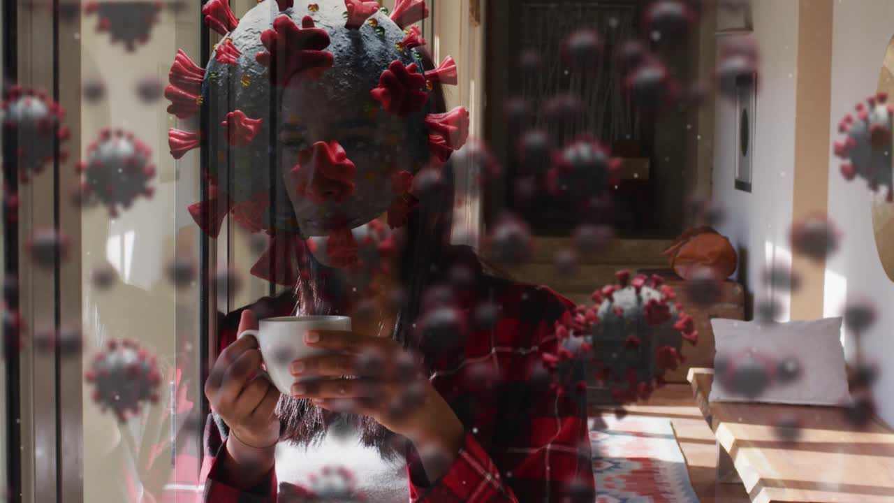 Woman holding object to face by window causing virus overlay drifting sipping cup reflecting health