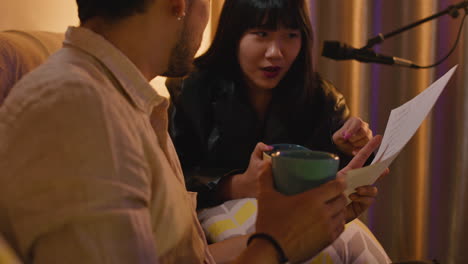 people having a conversation while reading a script in a studio