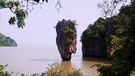 pillar rock island with vegetation in phang nga sea bay in thailand