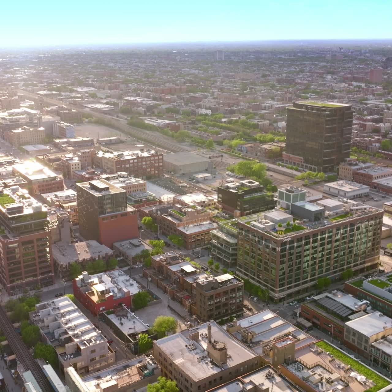 Sunlit buildings in the quarters of Chicago. Endless cityscape of metropolis at the backdrop of blue skies
