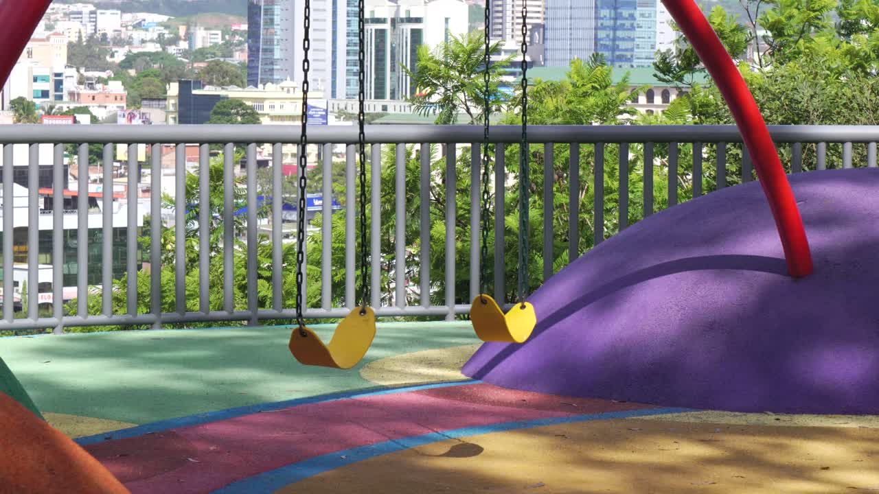 Urban public playground with colorful play area. Development Latin America. Tegucigalpa, Honduras. 4k.