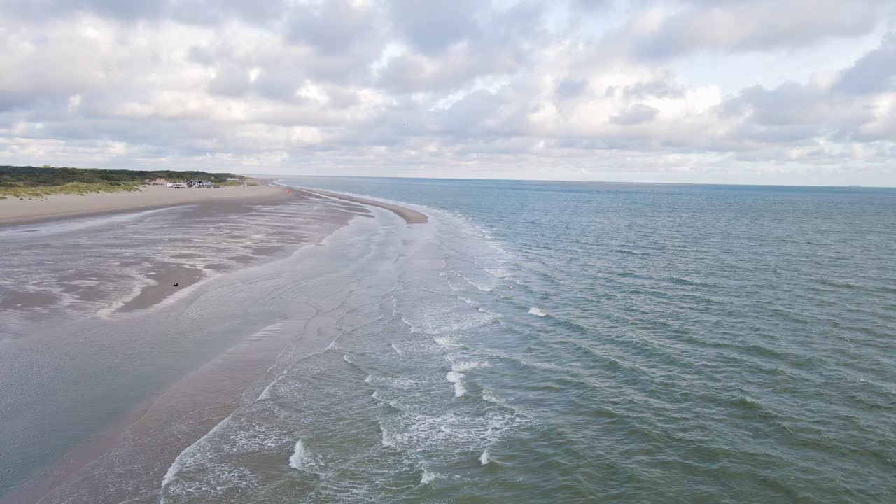 Aerial backwards shot over North Sea during ebb tide in Netherlands ...