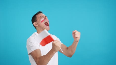 man cheering for poland waving a national flag looking away