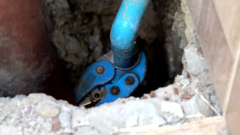 cutting pvc pipes-plumbing repair the water leak under concrete floor 4k footage video (selective focus)