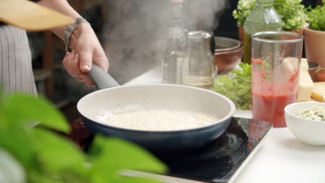 unrecognizable cook preparing risotto in pan