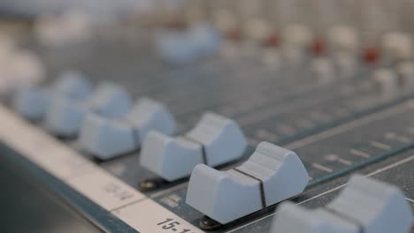 Audio control knob on professional equipment, close up handheld view