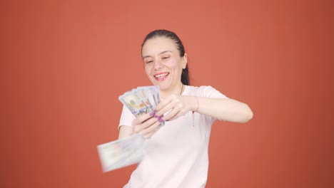 woman distributing banknotes and tossing them into the air.