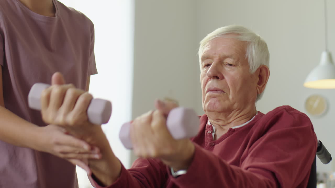 Eldelrly Man in Wheelchair Doing Dumbbell Exercise
