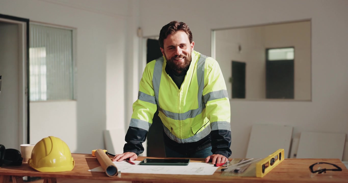 Male Construction Engineer Smiling at Camera in Office