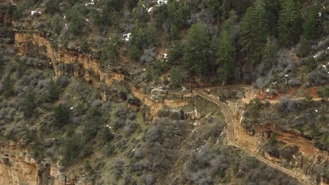 a slow zoom out from hikers at the grand canyon that reveals the scope and beauty of the location