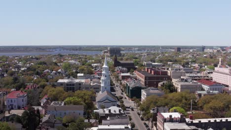 Wide-panning-aerial-shot-of-Saint-Michael's-Church-in-the-historic-French-Quarter-of-Charleston,-South-Carolina