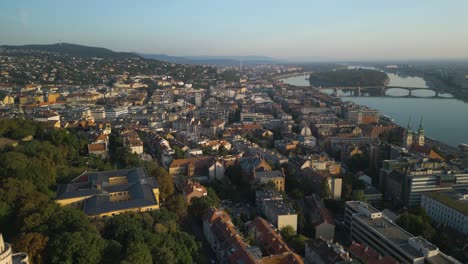 beautiful drone shot above buda at sunrise with margaret island in background