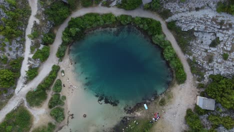 the dark depth of cetina river spring , also known as eye of the earth, a cold karst spring and deep sink hole, croatia