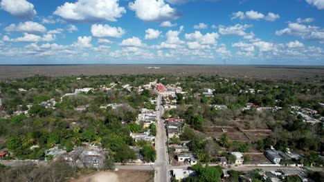 backwards drone shot of dar away ancient church at tahmek yucatan mexico during a very sunny day