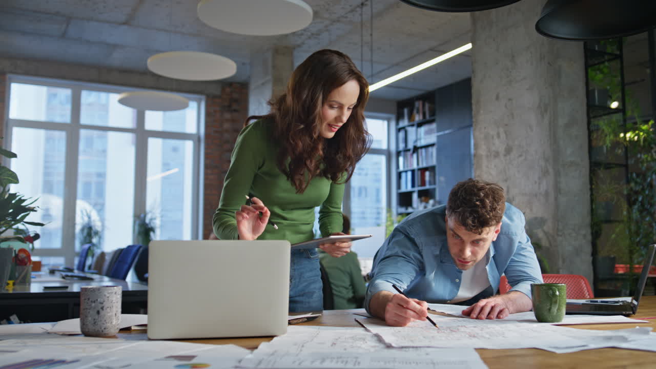 Two manager collaborating workplace looking documents office work papers closeup