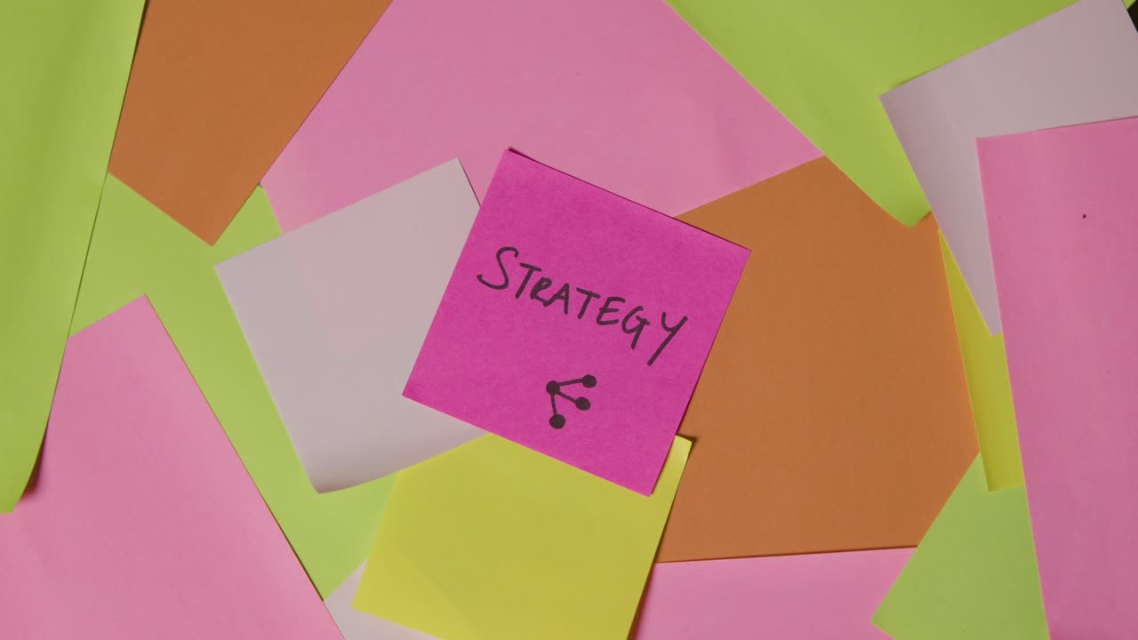 Business Concept Of Revolving Sticky Notes With Strategy Written On Top Note