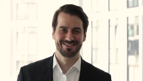 headshot of smiling confident businessman in suit look at camera