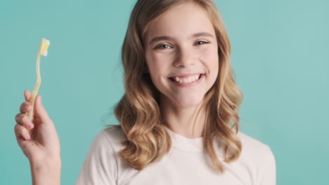 Teenage-Caucasian-girl-in-pijamas-brushing-her-teeth.