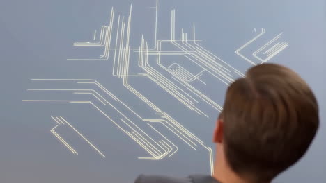 man looking at a futuristic glowing circuit or data network