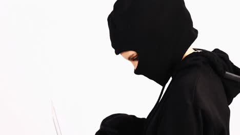 Female-burglar-doing-online-shopping-with-laptop-and-credit-card