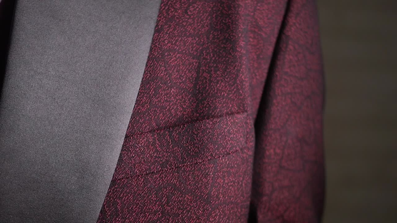 Close-up of a Hand on a Textured Maroon Suit Jacket