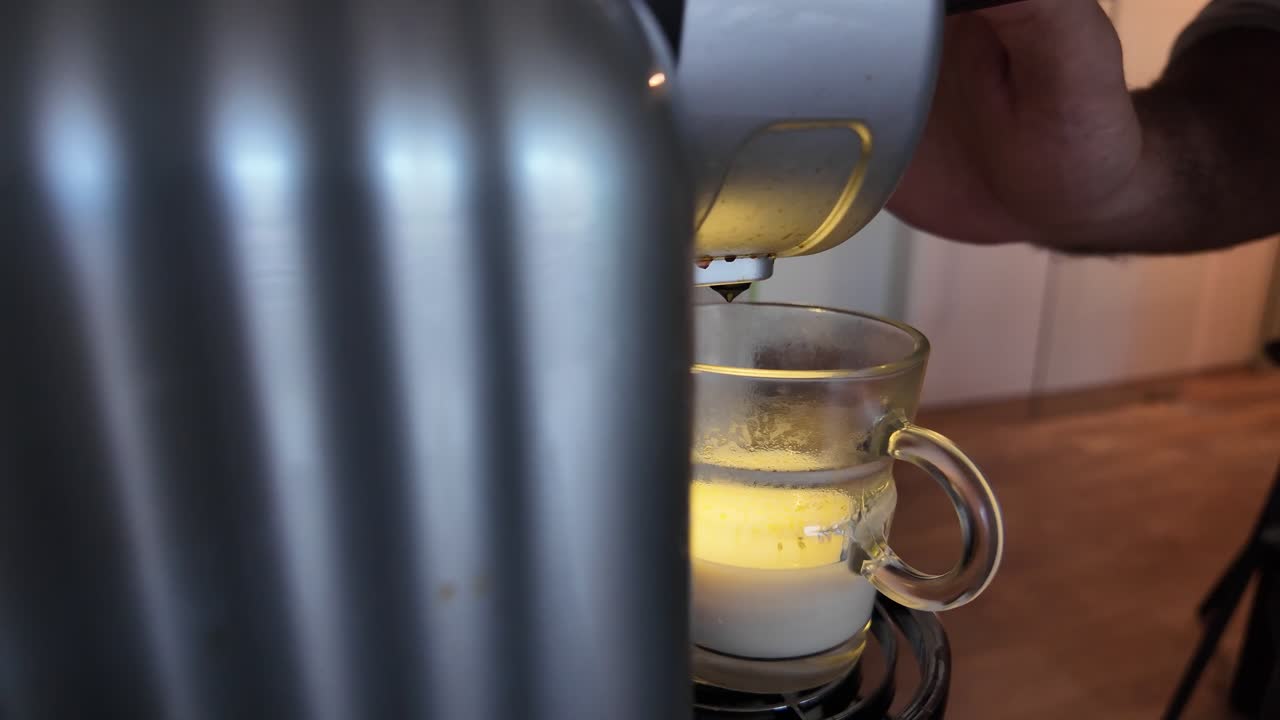 Slow motion detail of coffee machine preparing a fresh hot drink