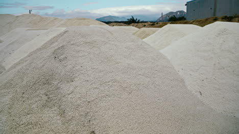 large piles of harvested salt in an outdoor landscape