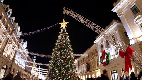 christmas tree installation in city street at night