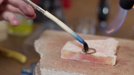 gold wedding ring getting handcrafted in the fire