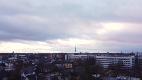 Riga-city-suburbs-apartment-building-and-TV-tower-in-horizon,-aerial-view