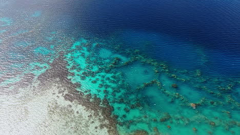 bora bora, french polynesia. revealing drone shot of lagoon and motu islets from coast of main island