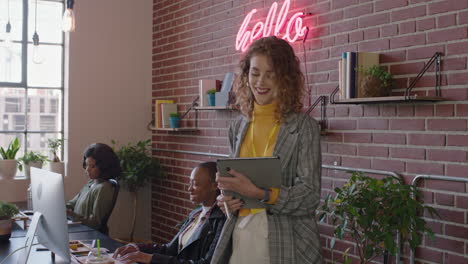 beautiful-caucasian-business-woman-team-leader-enjoying-management-career-checking-colleagues-working-using-tablet-computer-in-diverse-office-workplace-walking-confident-female-manager