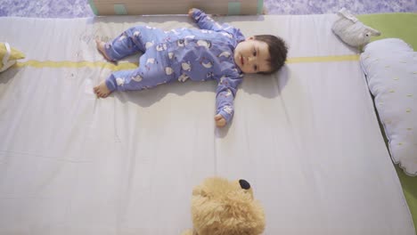 baby looking at his toy and laughing.