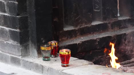 candles flicker near a cozy brick fireplace.