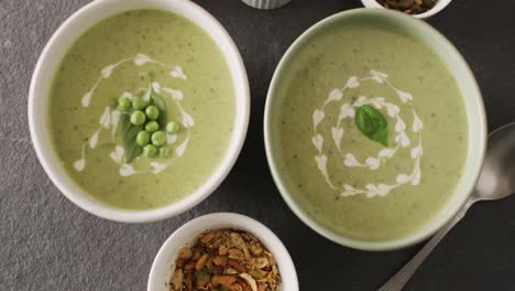 video of green peas soup and ingredients lying on grey surface