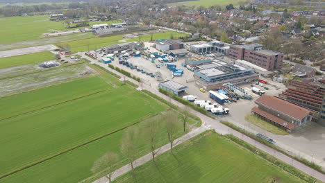 aerial of recycling station with garbage trucks parked on terrain