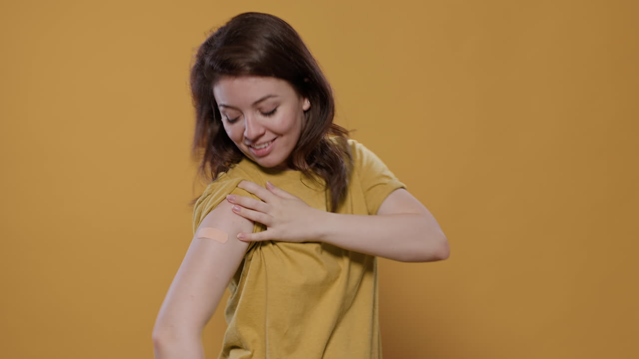 Woman proudly showing her vaccination patch