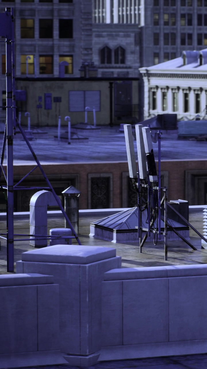 Cell towers on a building rooftop in an urban city at night